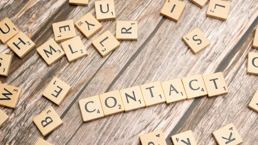 Scrabble letter tiles spelling the word contact